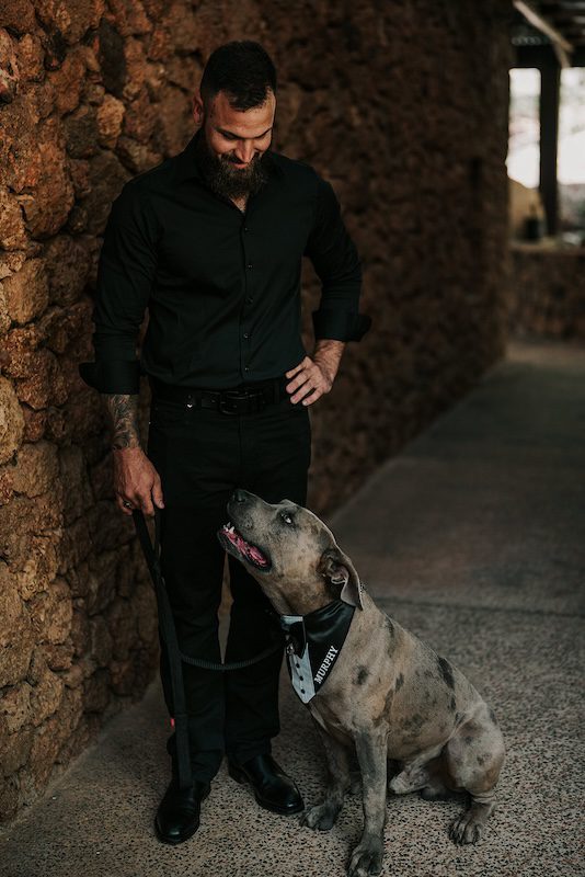Groomsman-Alex-posing-with-pet-American-Staffordshire-Terrier-Murphy